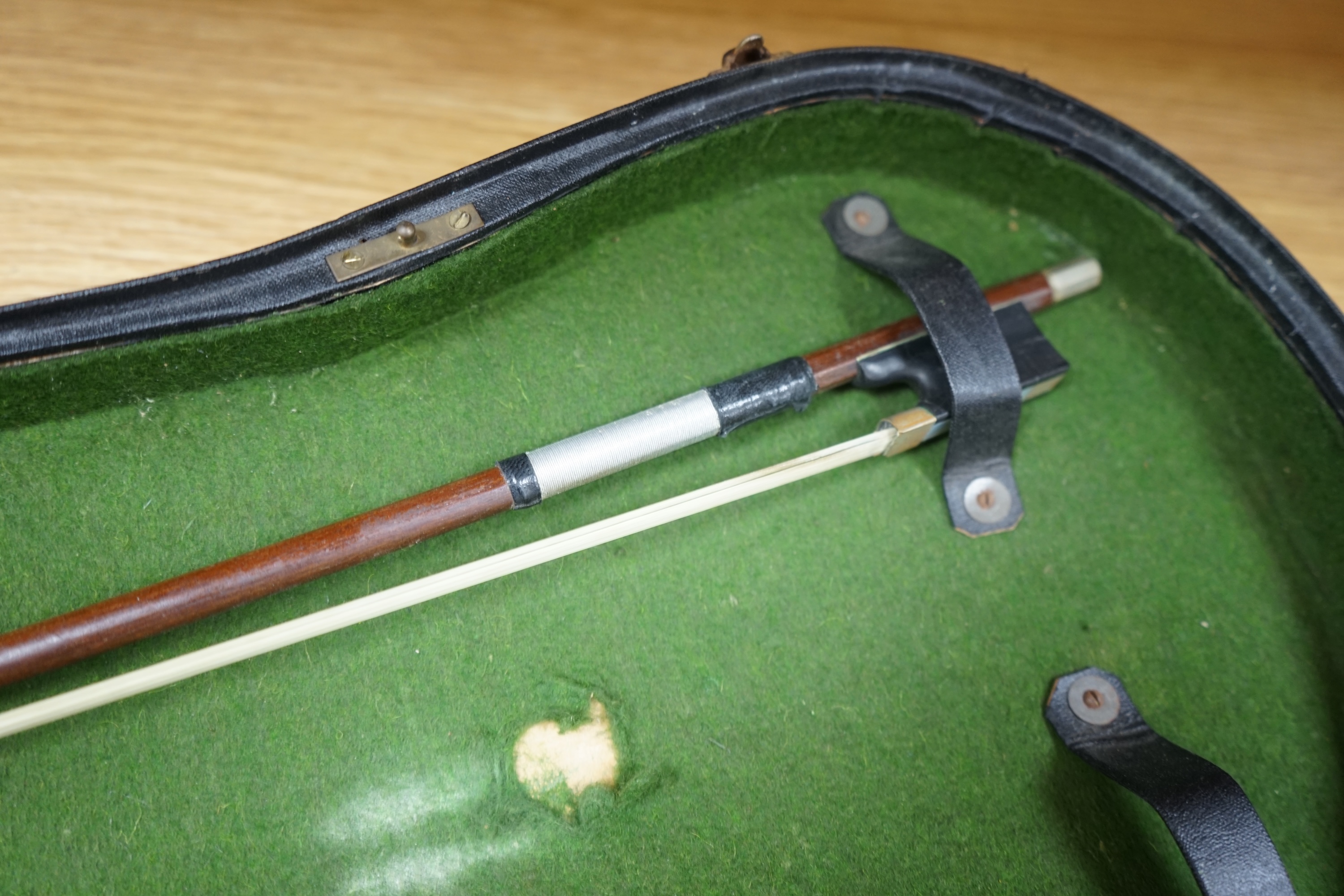 A cased early 20th century violin with bow, no label, back measures 35.5cm. Condition - fair to good